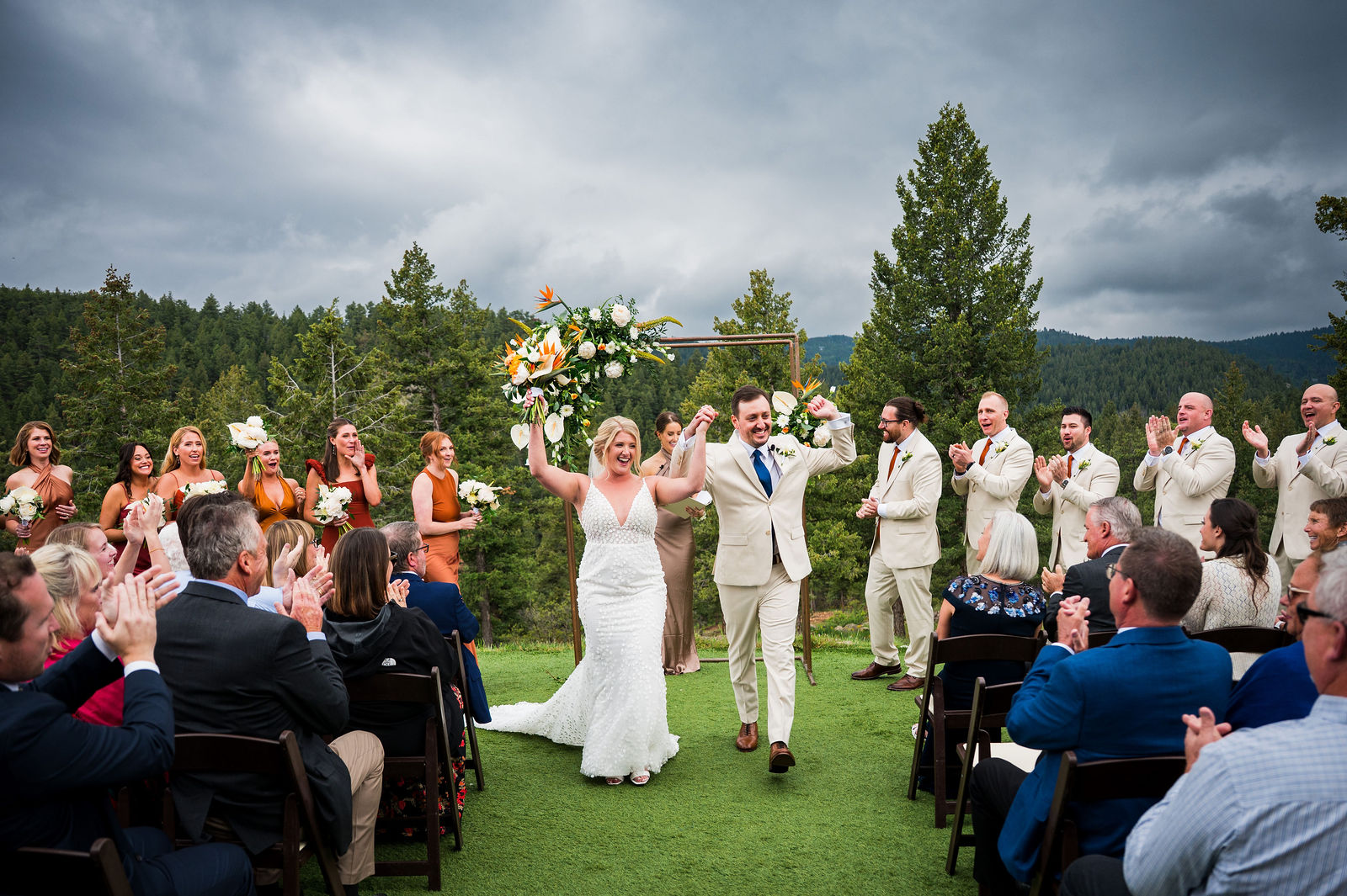 Bride and groom celebrating their recessional at a Colorado mountain wedding