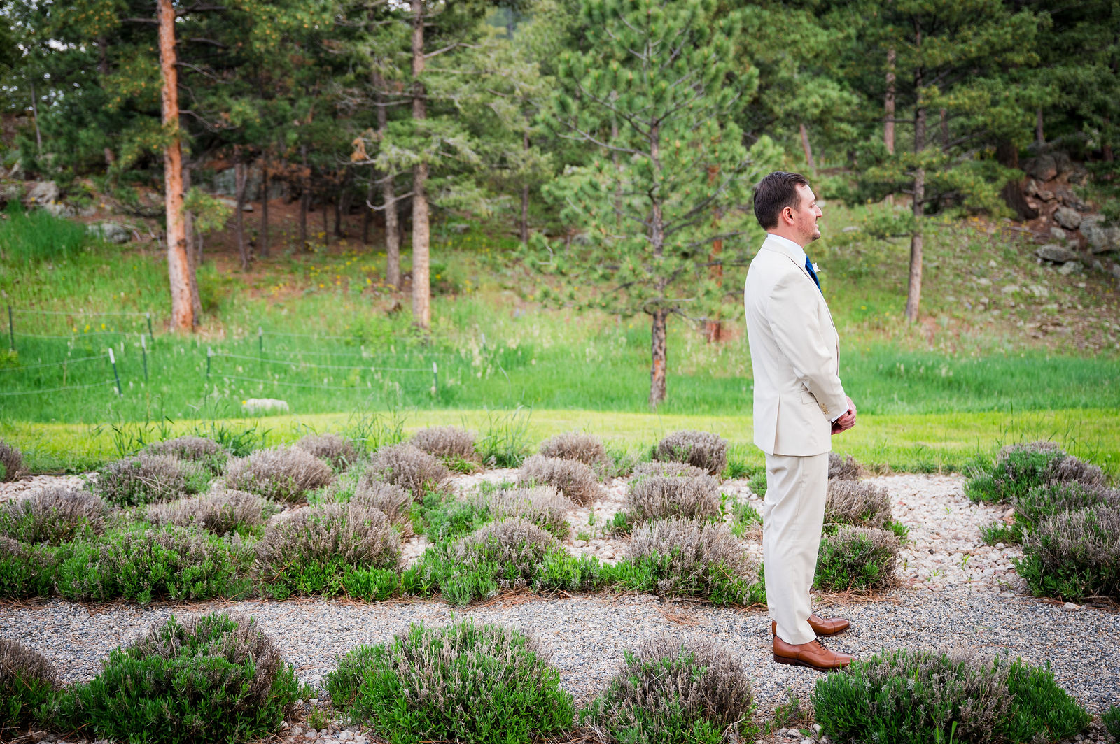 Bride walking up behind the groom for their first look at The Woodlands