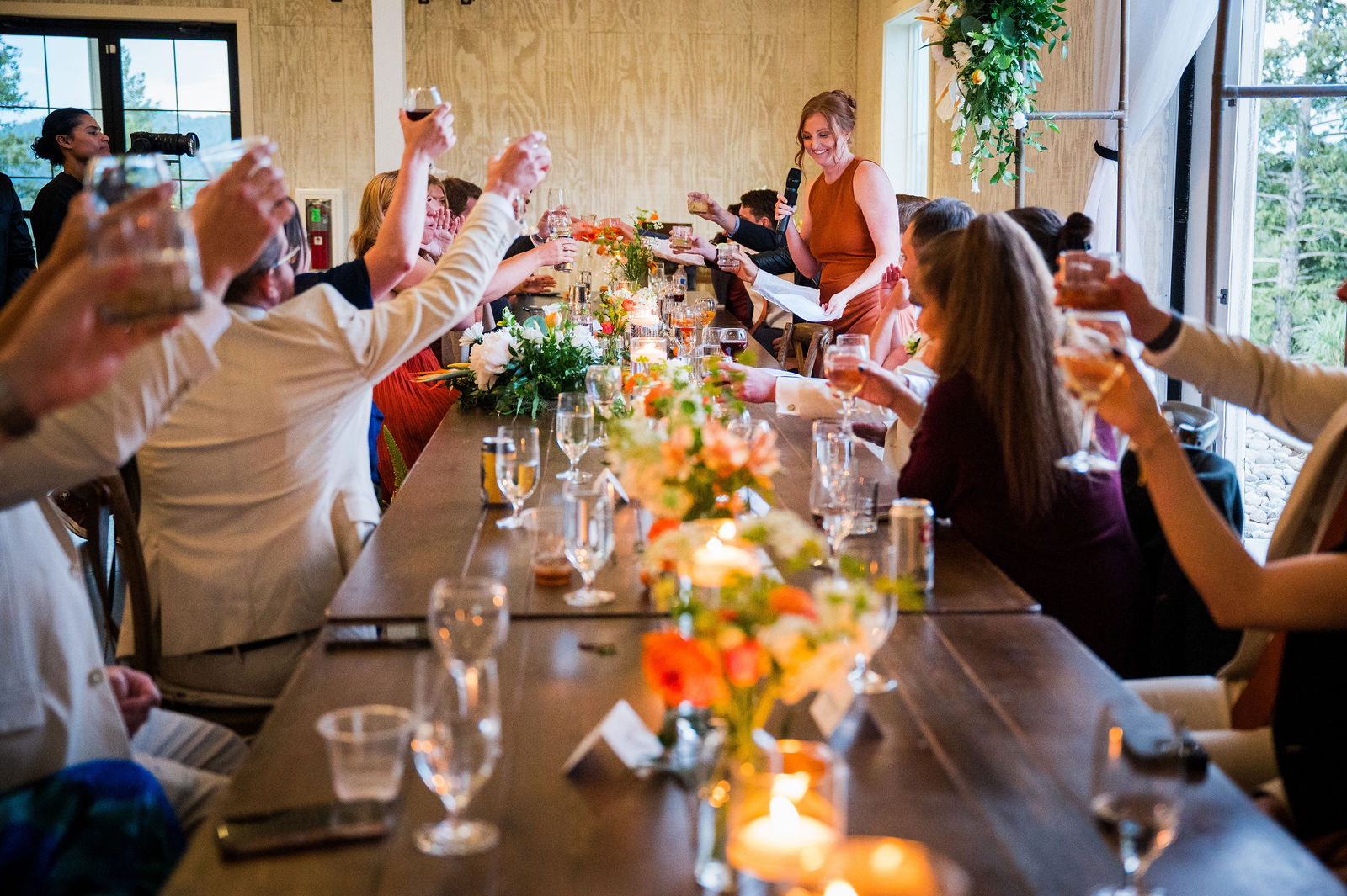 Guests raising a toast at a wedding reception in Morrison Colorado