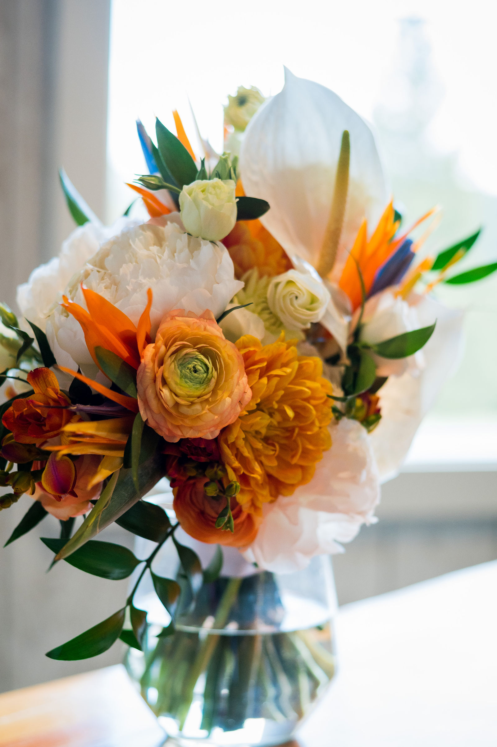 Reception centerpiece with Bird of Paradise and orange blooms in Colorado