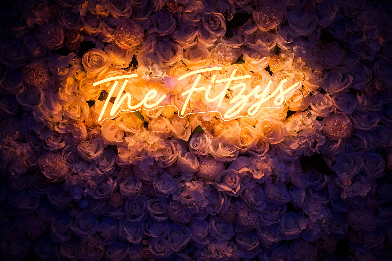 The Fitzys neon sign glowing at night at The Woodlands in Morrison Colorado