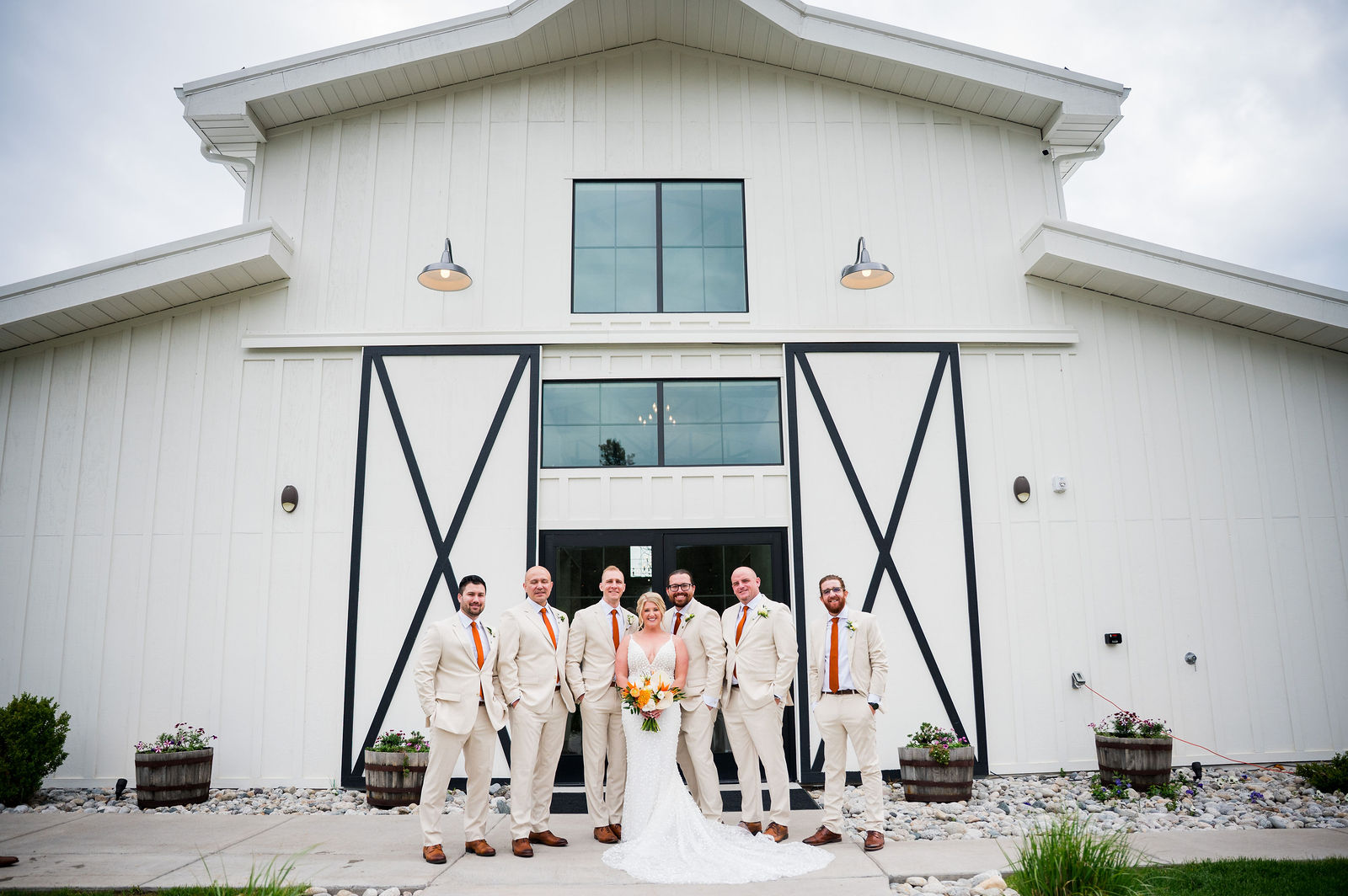 Bridesmaids in front of the white barn at The Woodlands in Morrison Colorado