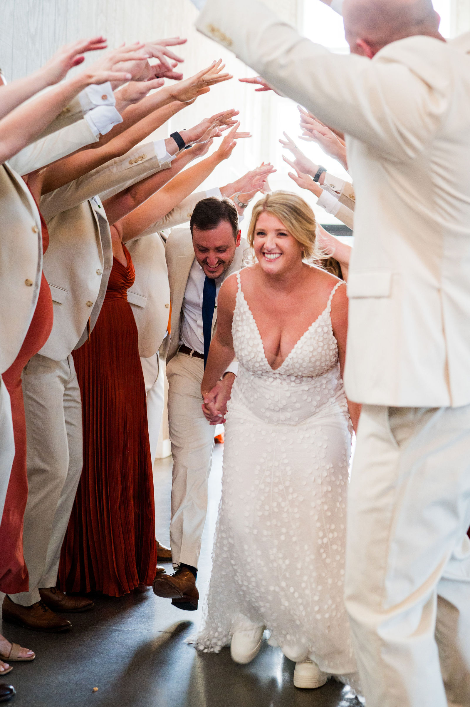 Grand entrance under a tunnel of arms at a Woodlands Colorado wedding reception