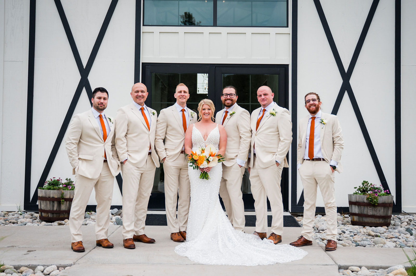 Bride and groomsmen in front of the barn at The Woodlands Colorado wedding venue