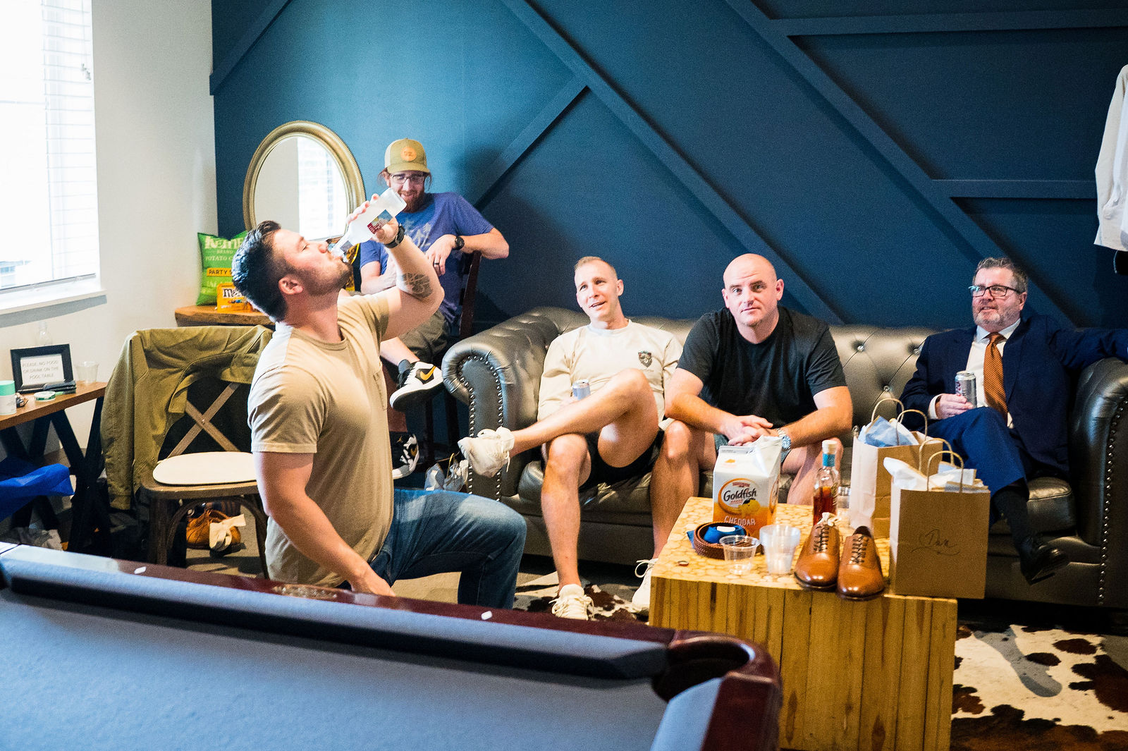 Groomsmen hanging out in the game room before a Woodlands Colorado wedding