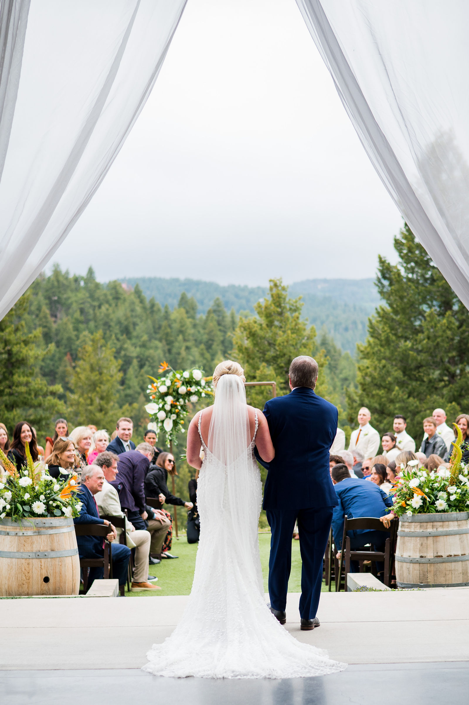 Bride silhouetted in the barn doorway before walking down the aisle in Morrison Colorado