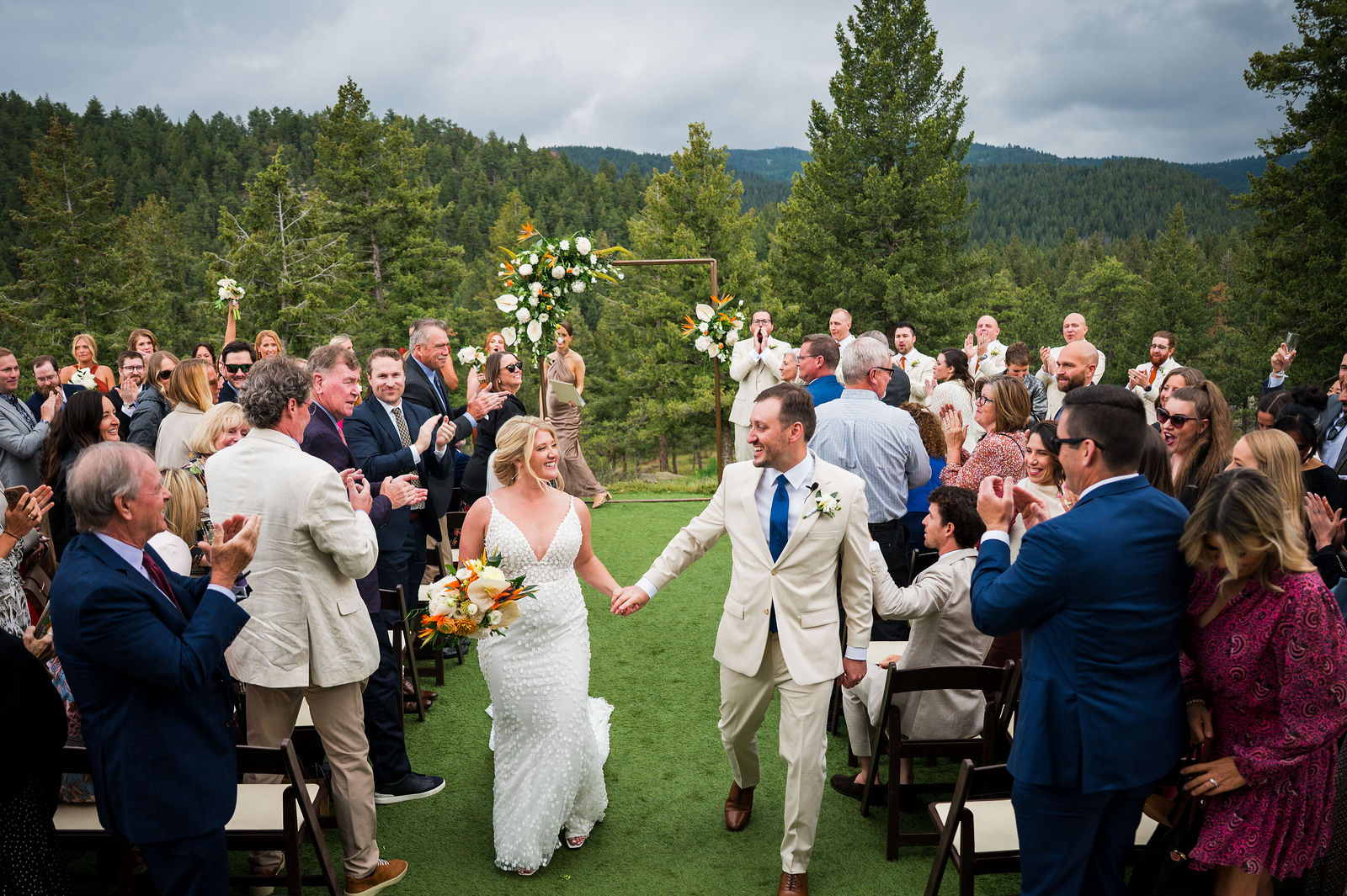 Newlyweds walking back up the aisle at The Woodlands wedding venue