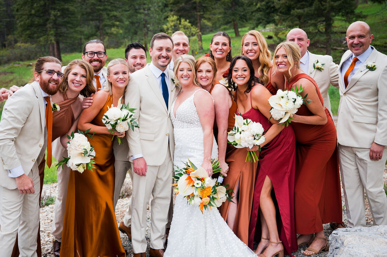 Wedding party celebrating with the bride and groom at a Colorado mountain wedding