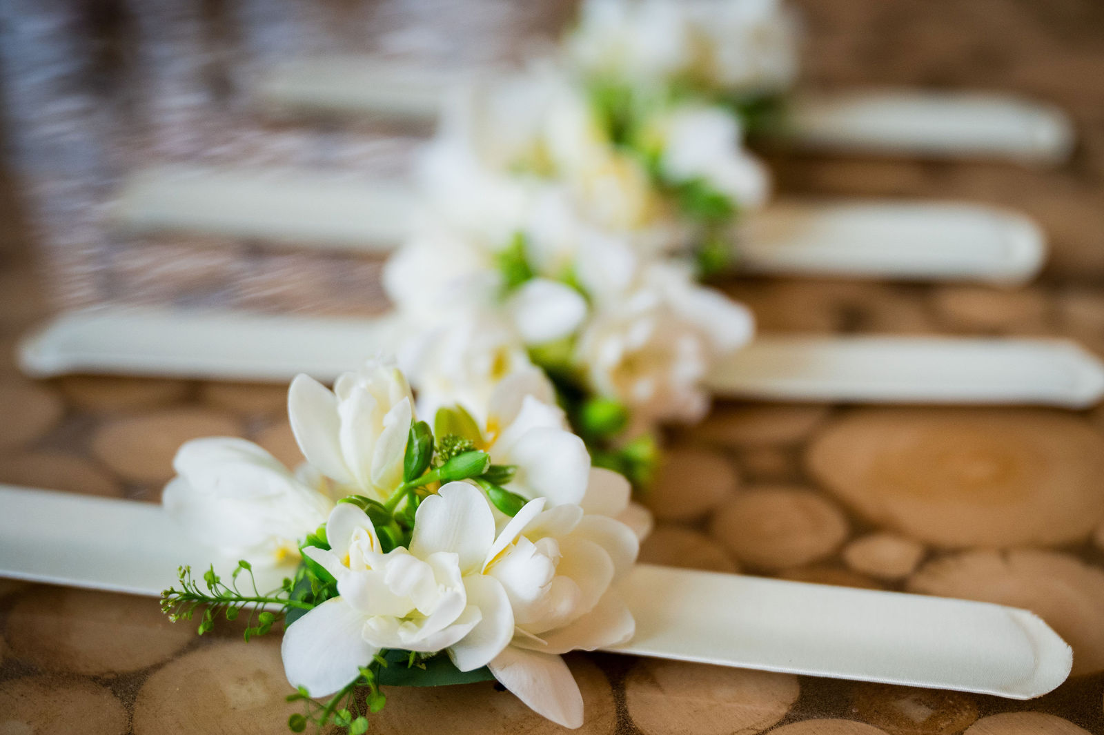 Wedding dress hanging on a stairway with white florals before a Woodlands Colorado wedding