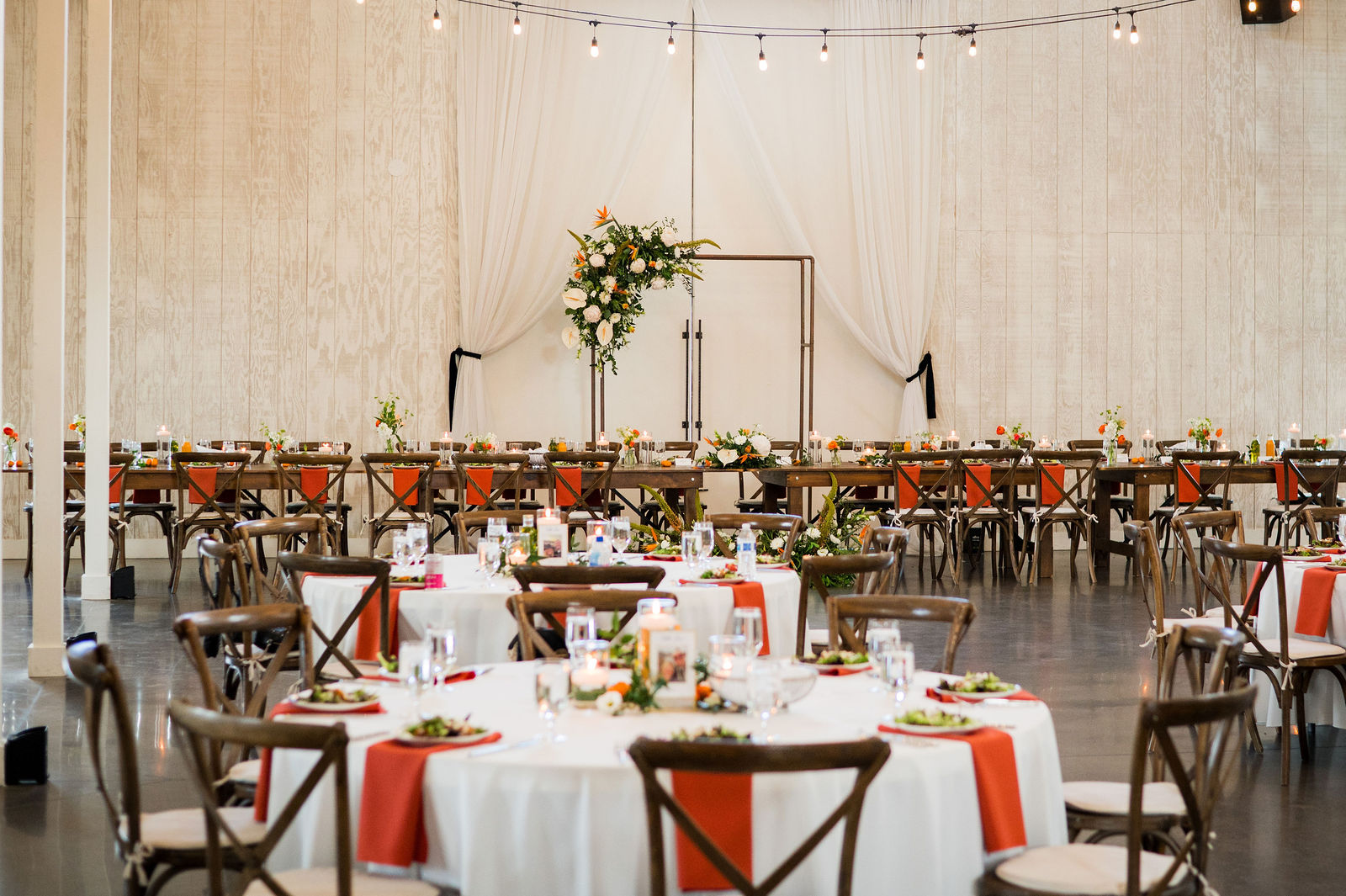 Barn reception room set for dinner at The Woodlands wedding venue in Colorado