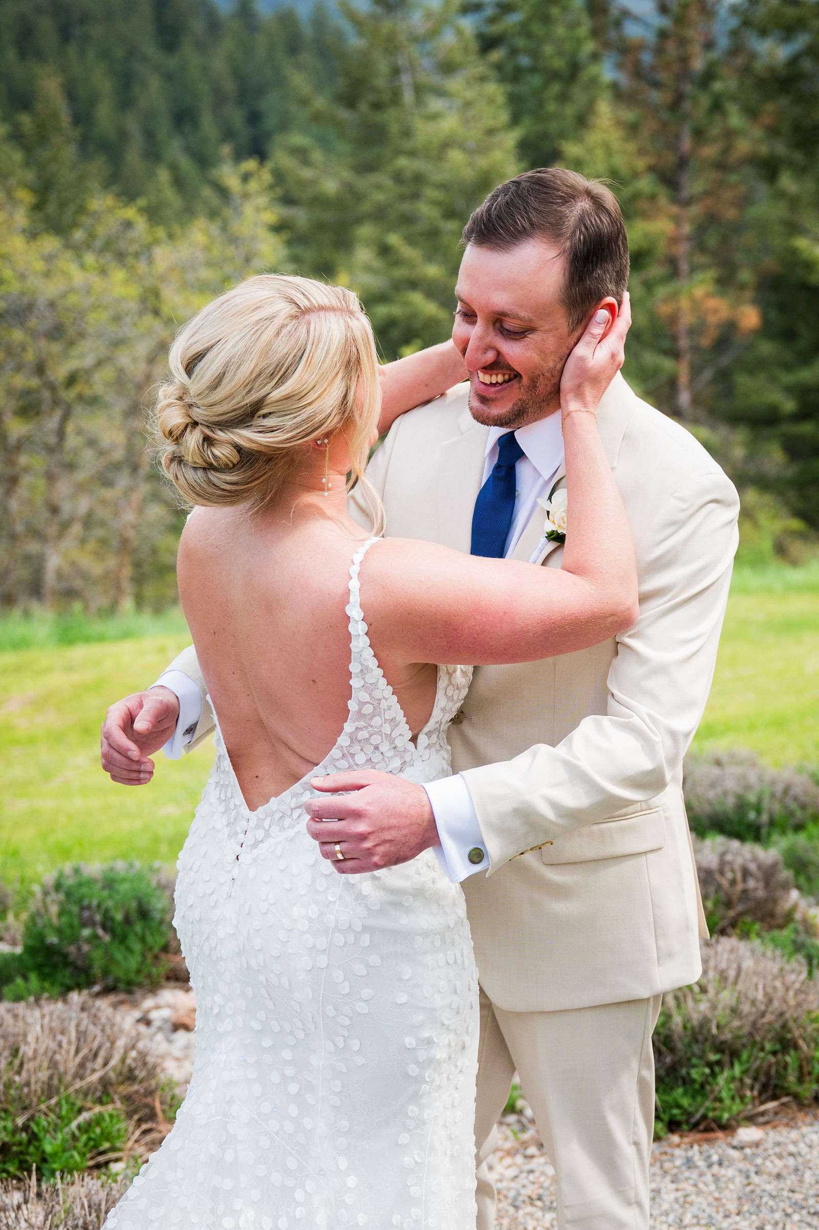 Bride and groom embracing during their first look at a Colorado mountain wedding