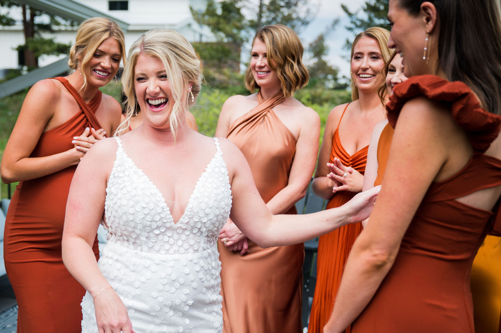 Bridesmaids laughing with the bride before her Woodlands Colorado wedding
