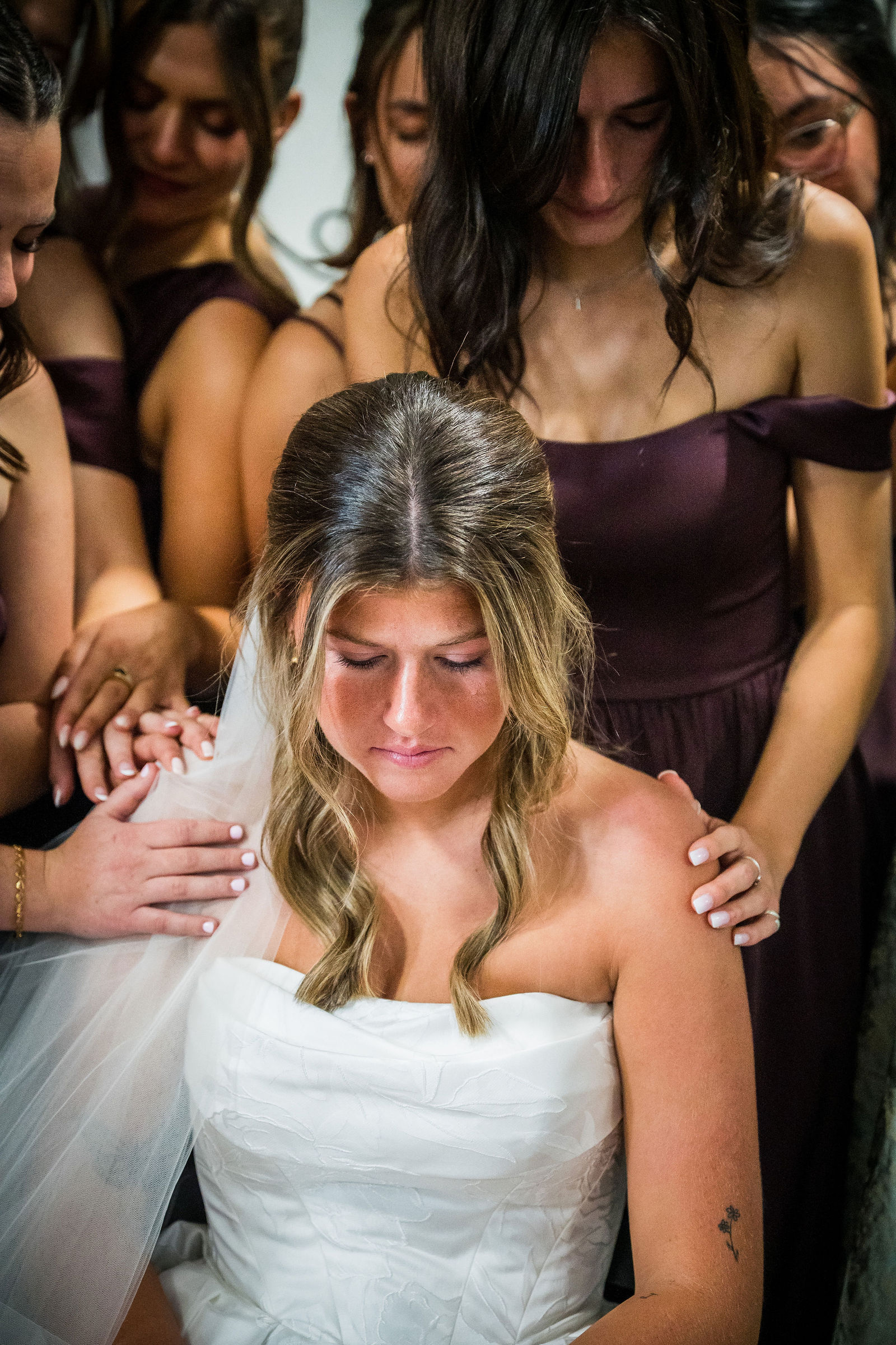 Bride emotional while being prayed over before her wedding