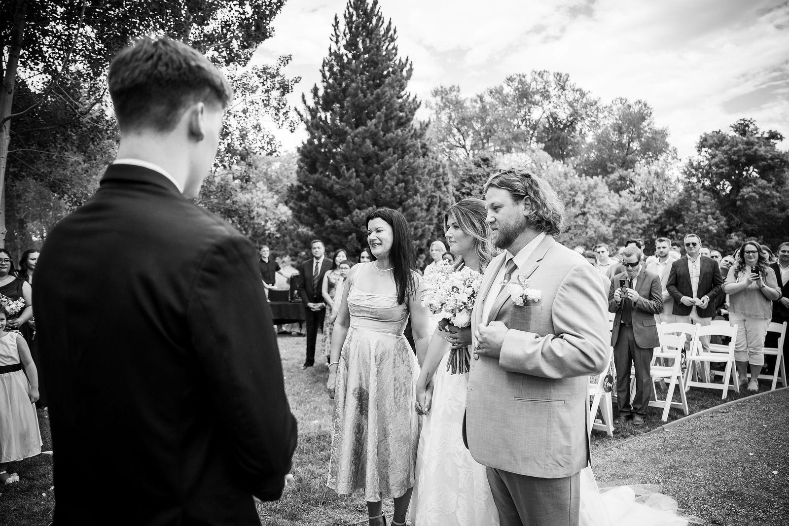 The handoff at the end of the aisle at a Colorado wedding