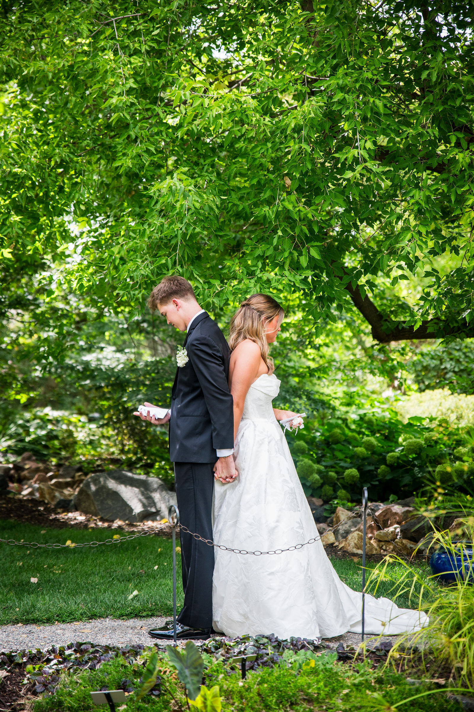 Couple standing back to back during a first touch at Chatfield Farms