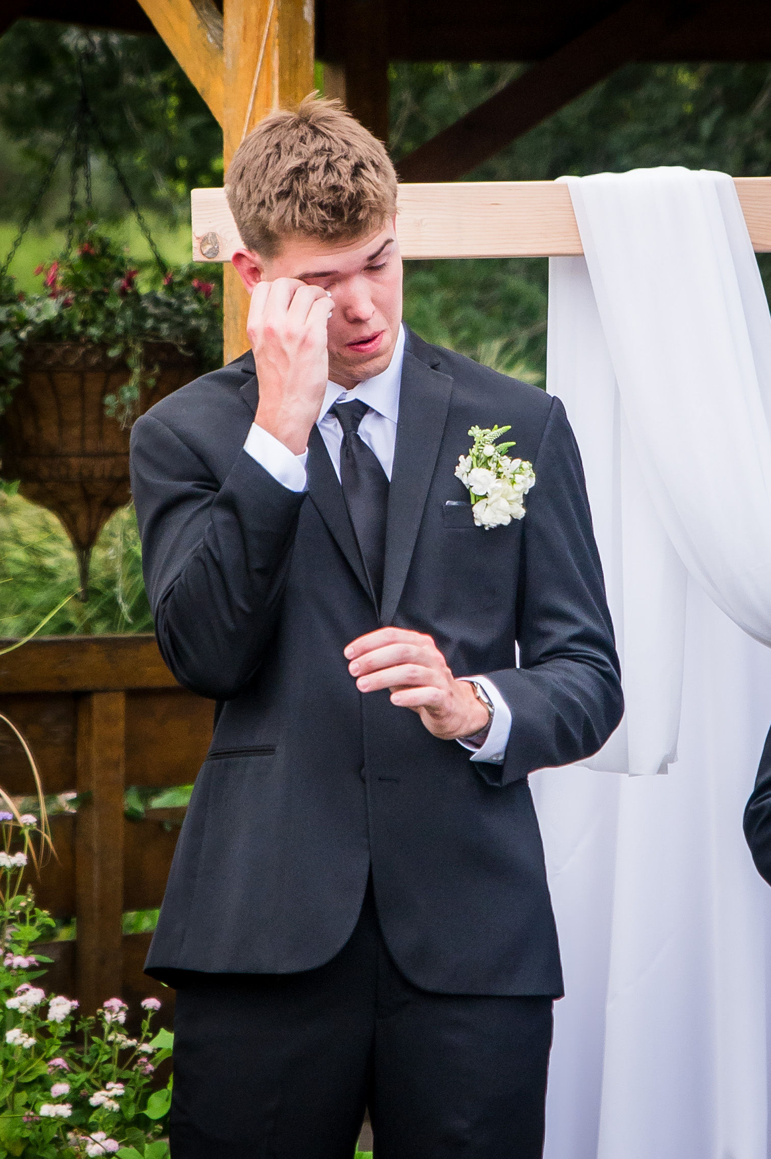 Groom wiping his eyes during the ceremony