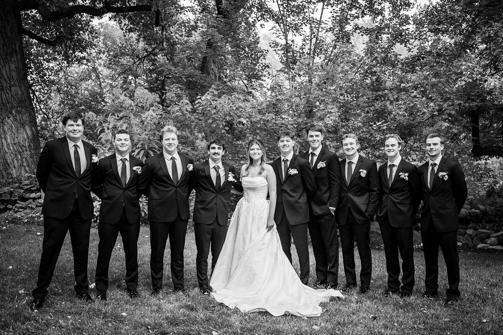 Bride with all nine groomsmen at Chatfield Farms