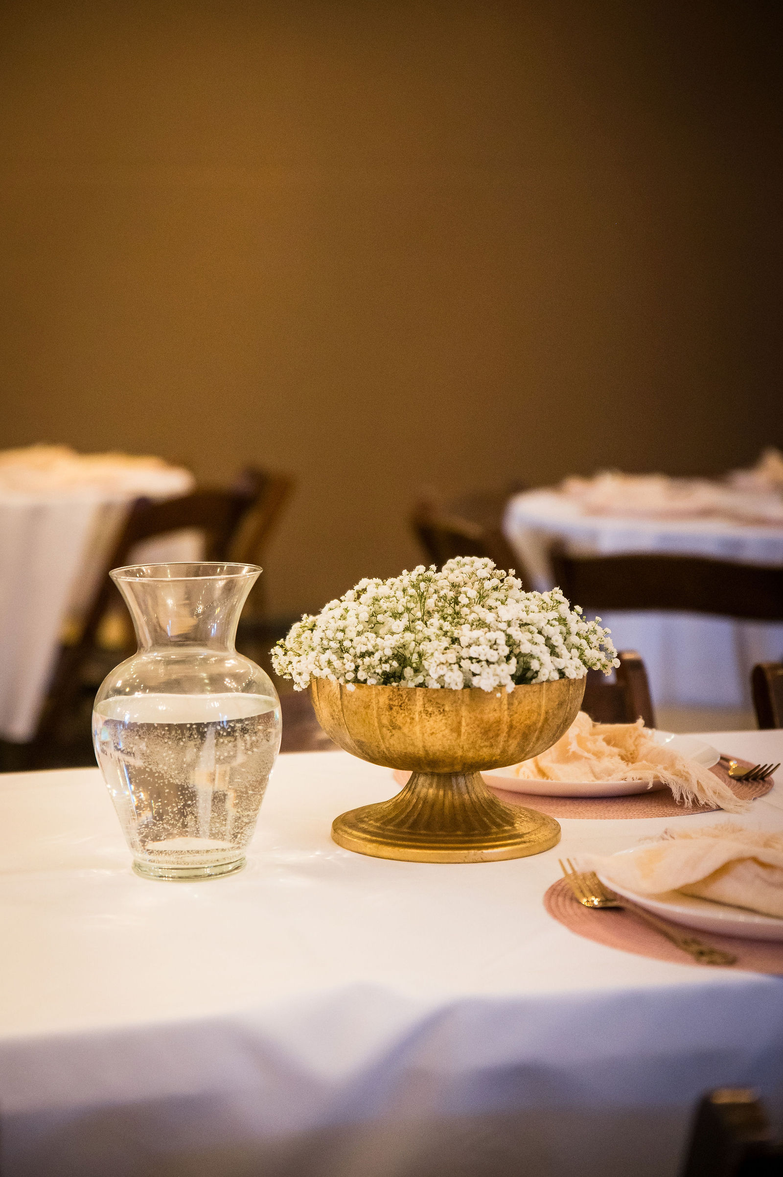 Baby’s breath centerpiece with gold candlesticks