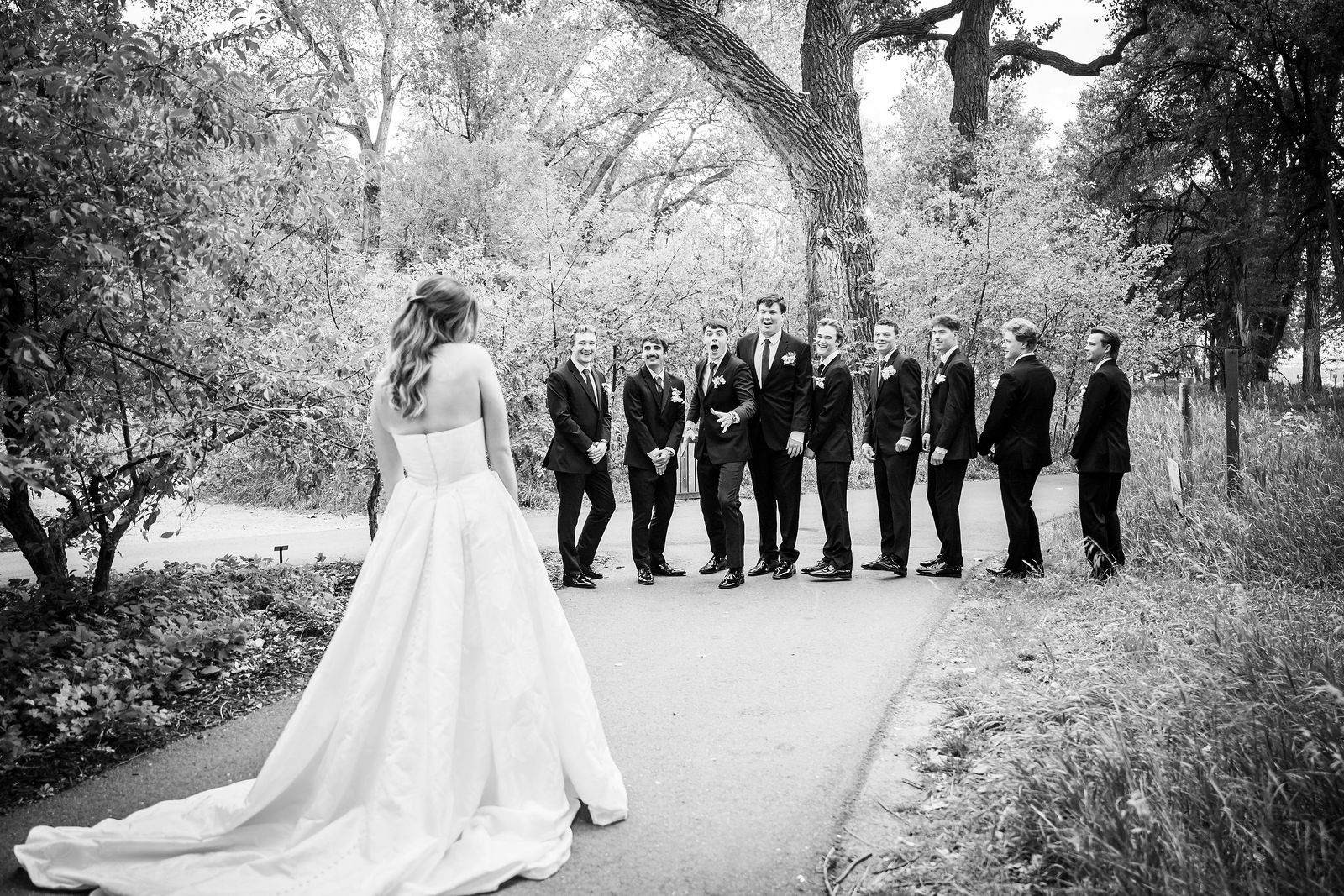 Groomsmen standing with their backs turned before the first look