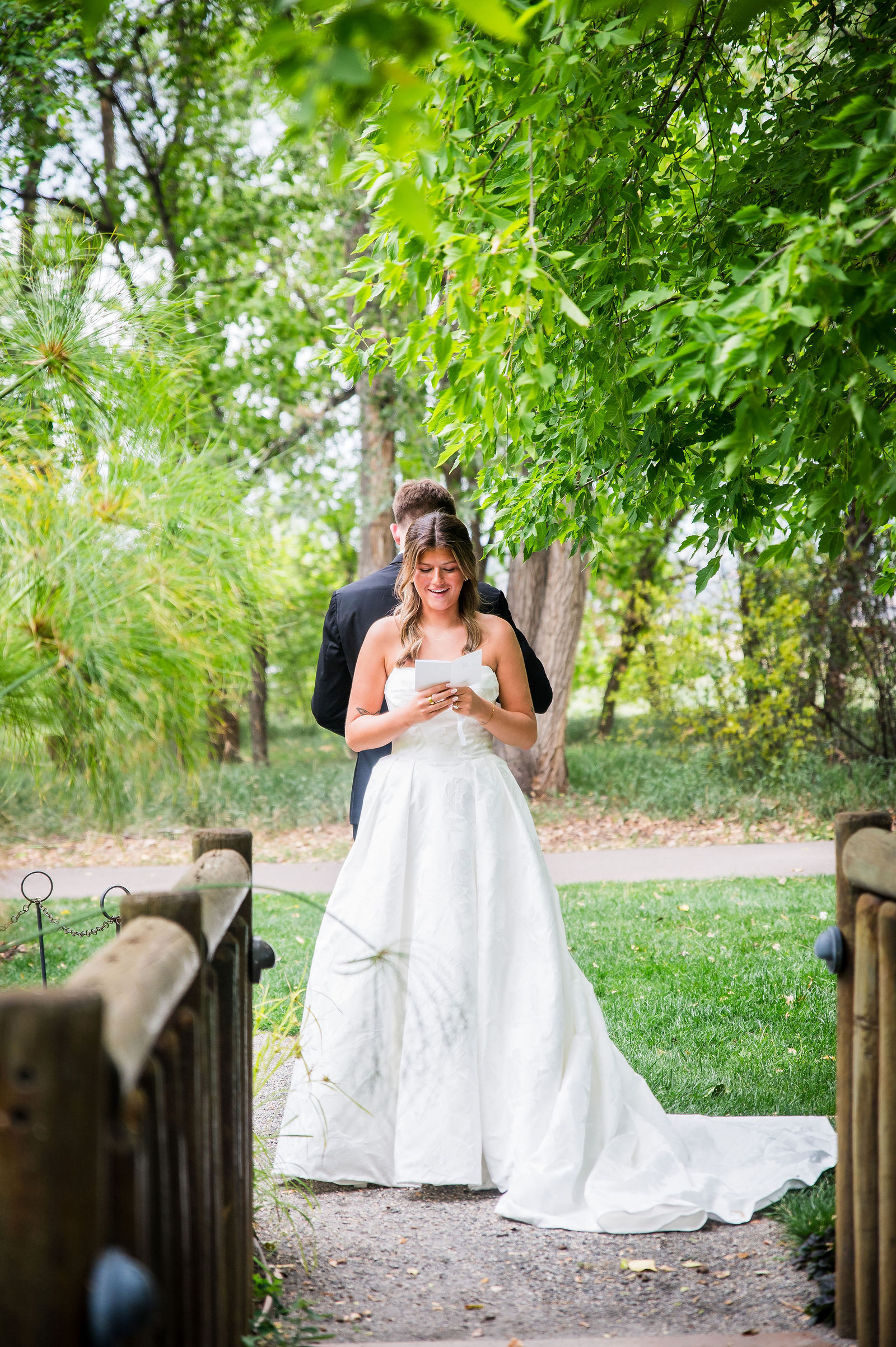 Bride and groom standing apart in the garden for their private vows