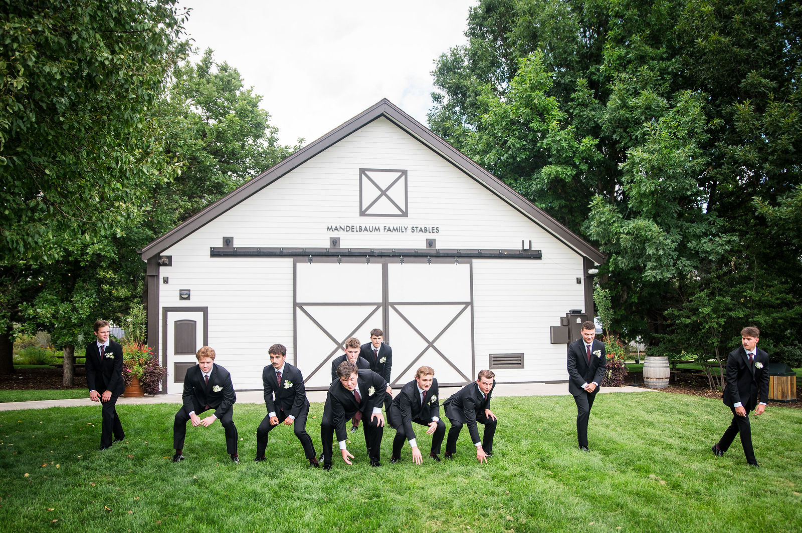 Wedding party outside a white barn venue in Colorado
