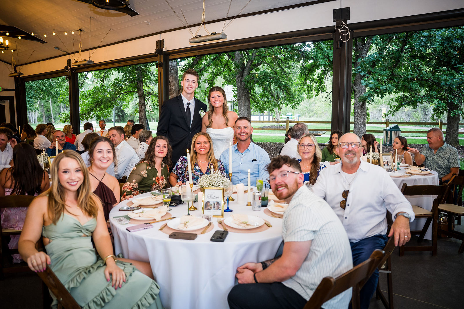 Bride and groom with a table of guests at their reception
