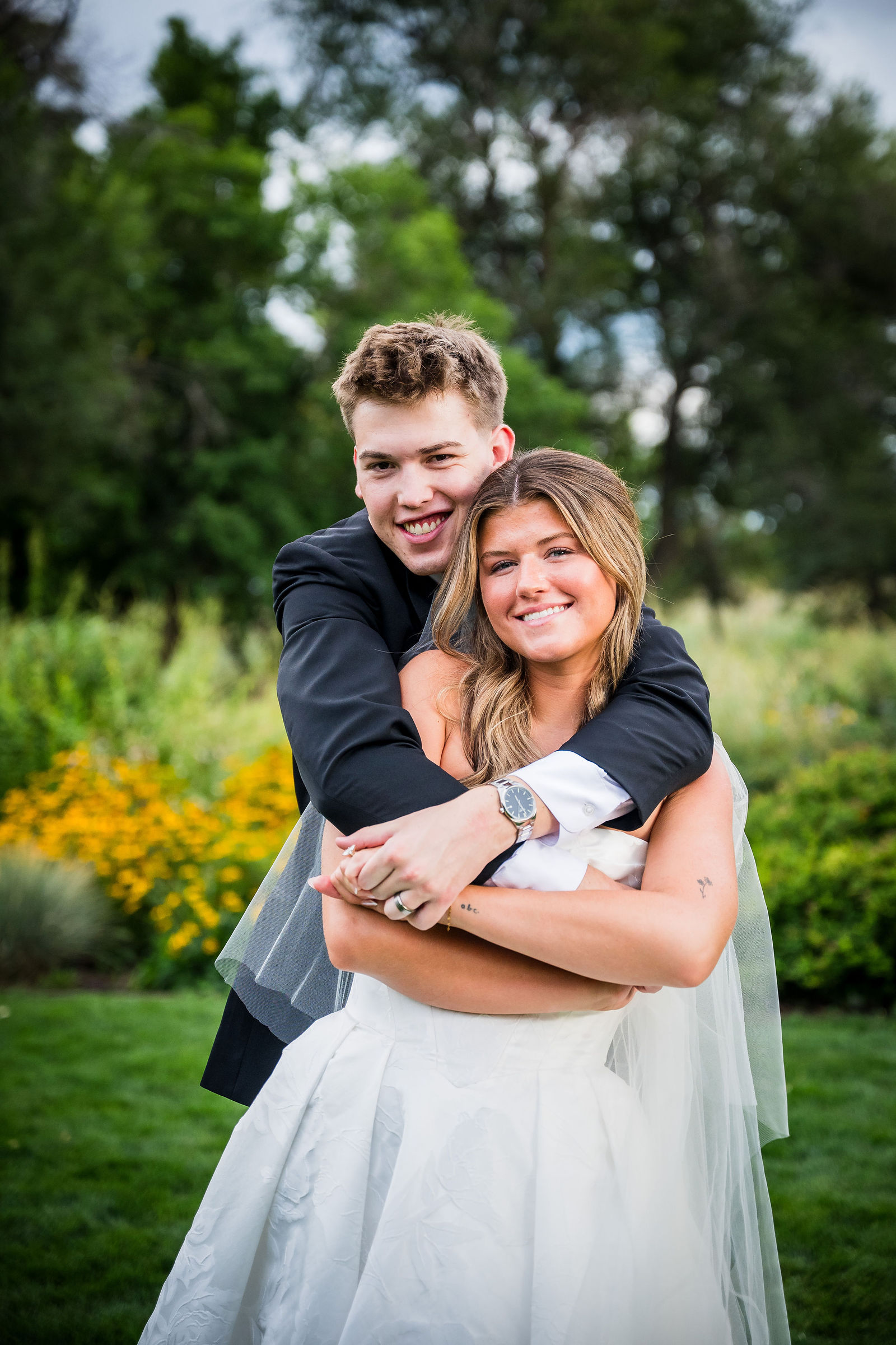 Bride and groom laughing together at golden hour
