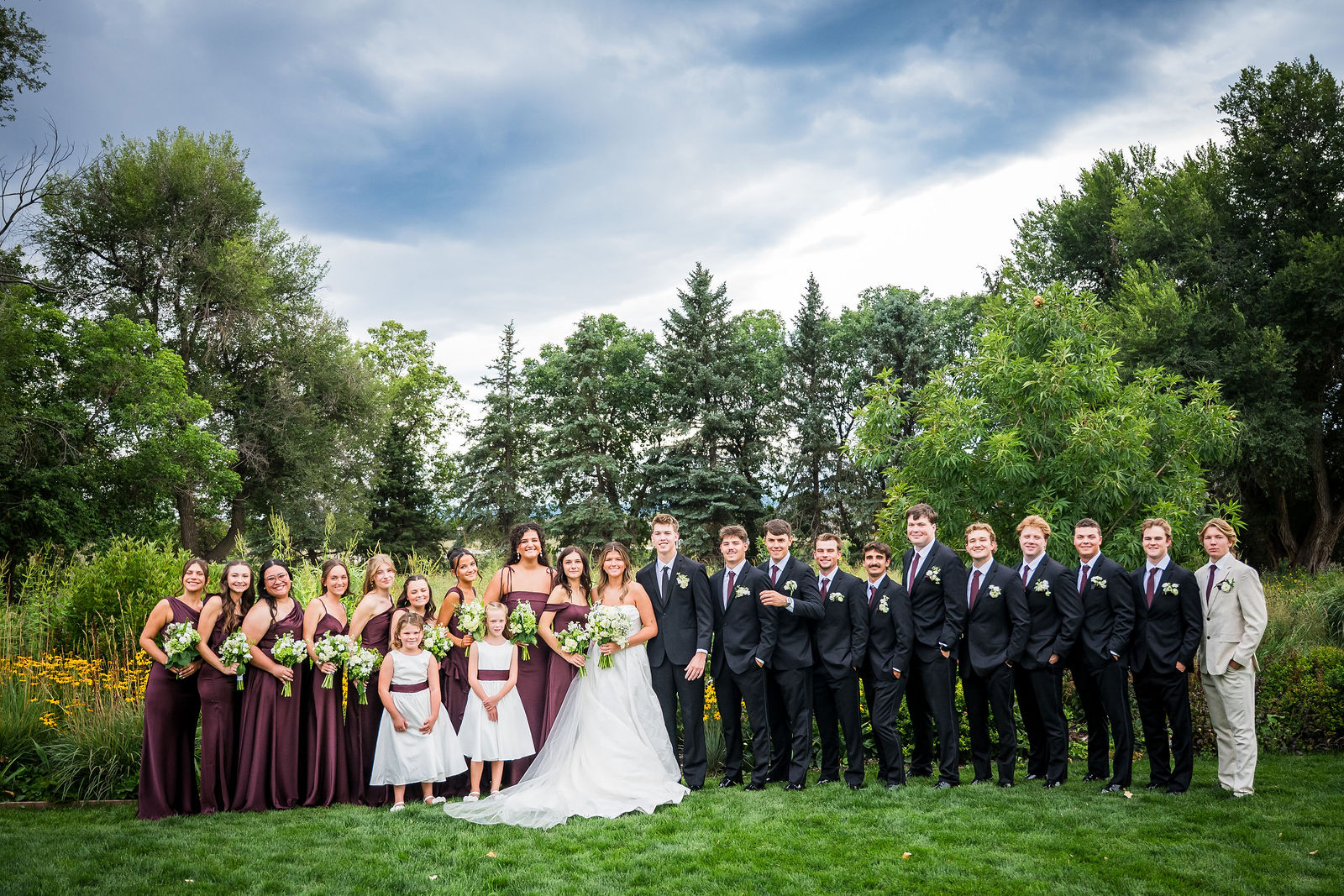 The full wedding party of twenty at Denver Botanic Gardens Chatfield Farms