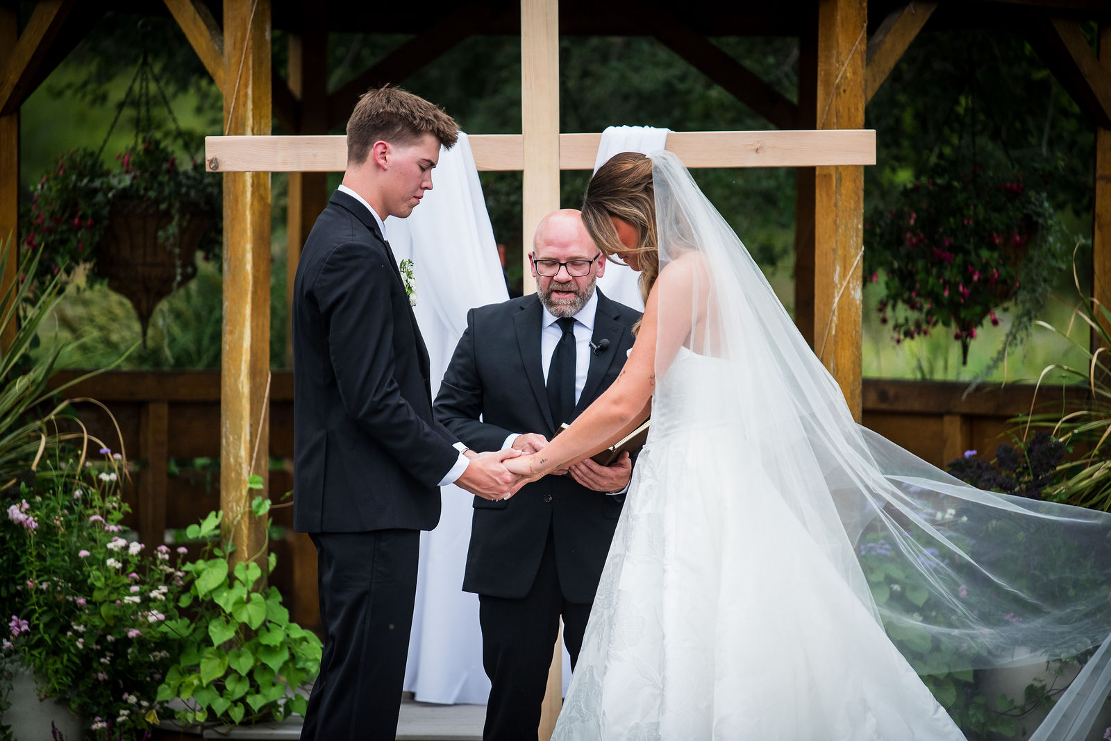 Bride and groom at the altar under the gazebo at Chatfield Farms