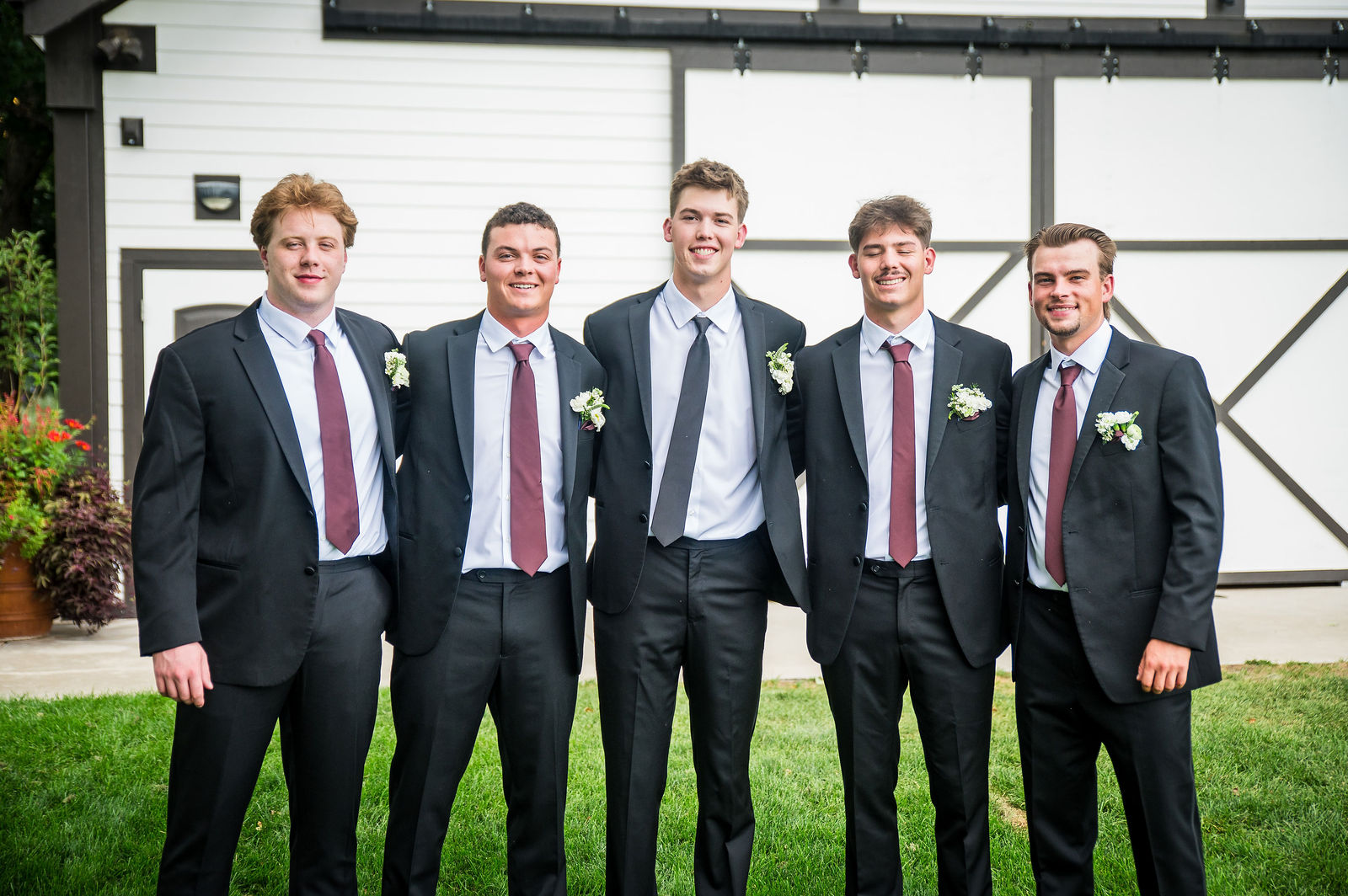 Nine groomsmen at the white barn at Chatfield Farms