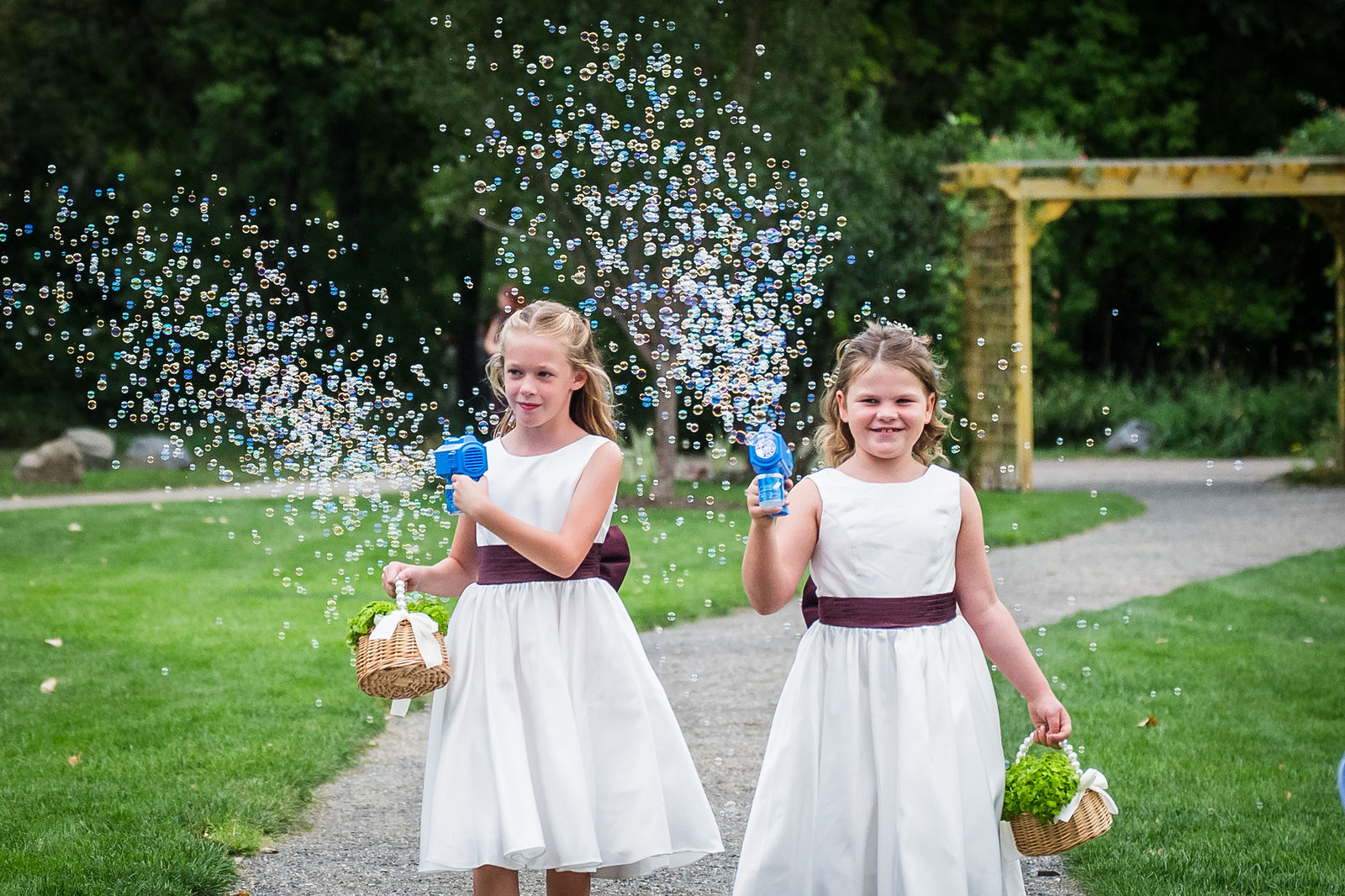 Flower girls walking the aisle at a Colorado garden wedding