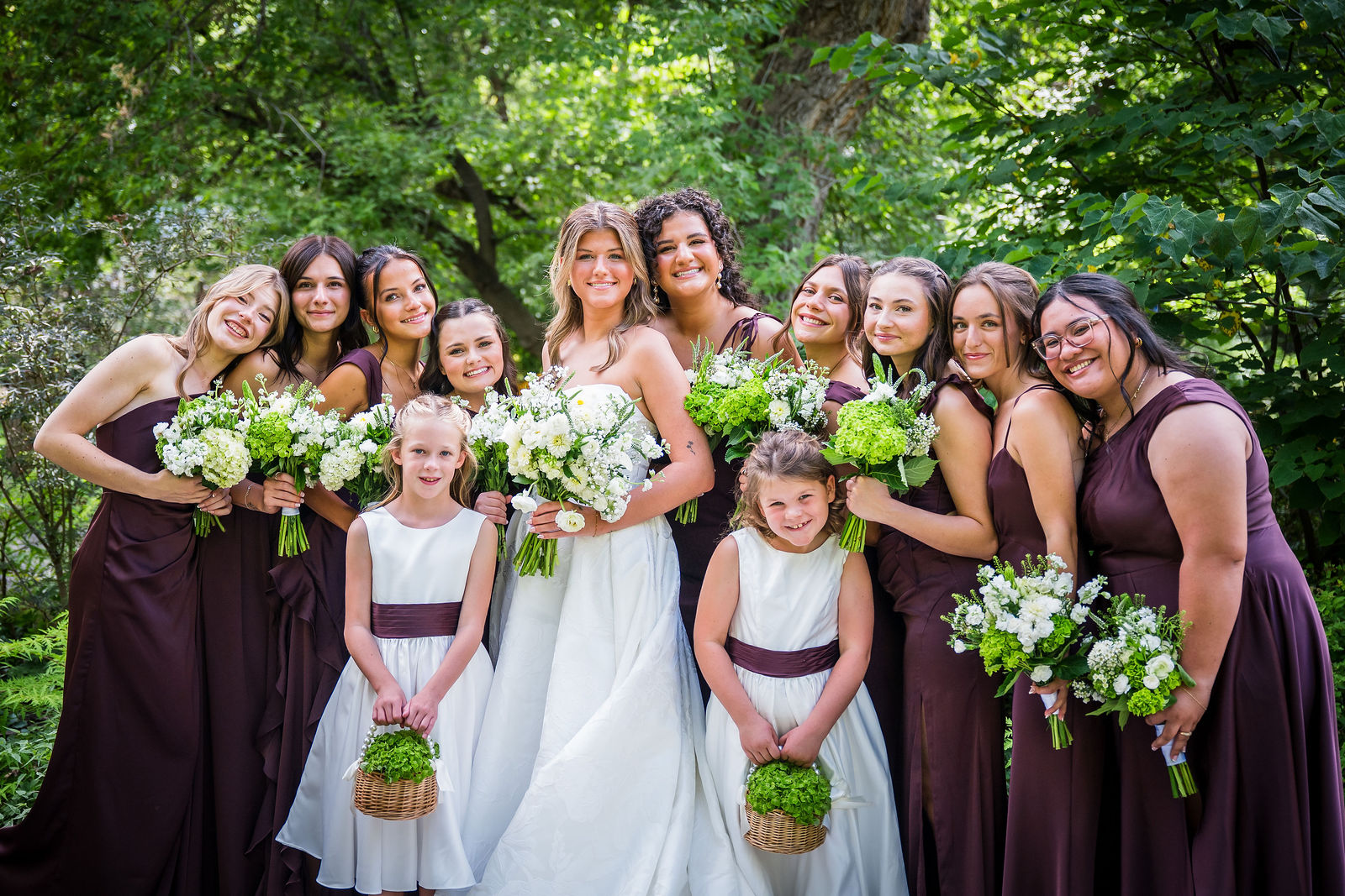 Bridesmaids in deep plum with the flower girls at Chatfield Farms