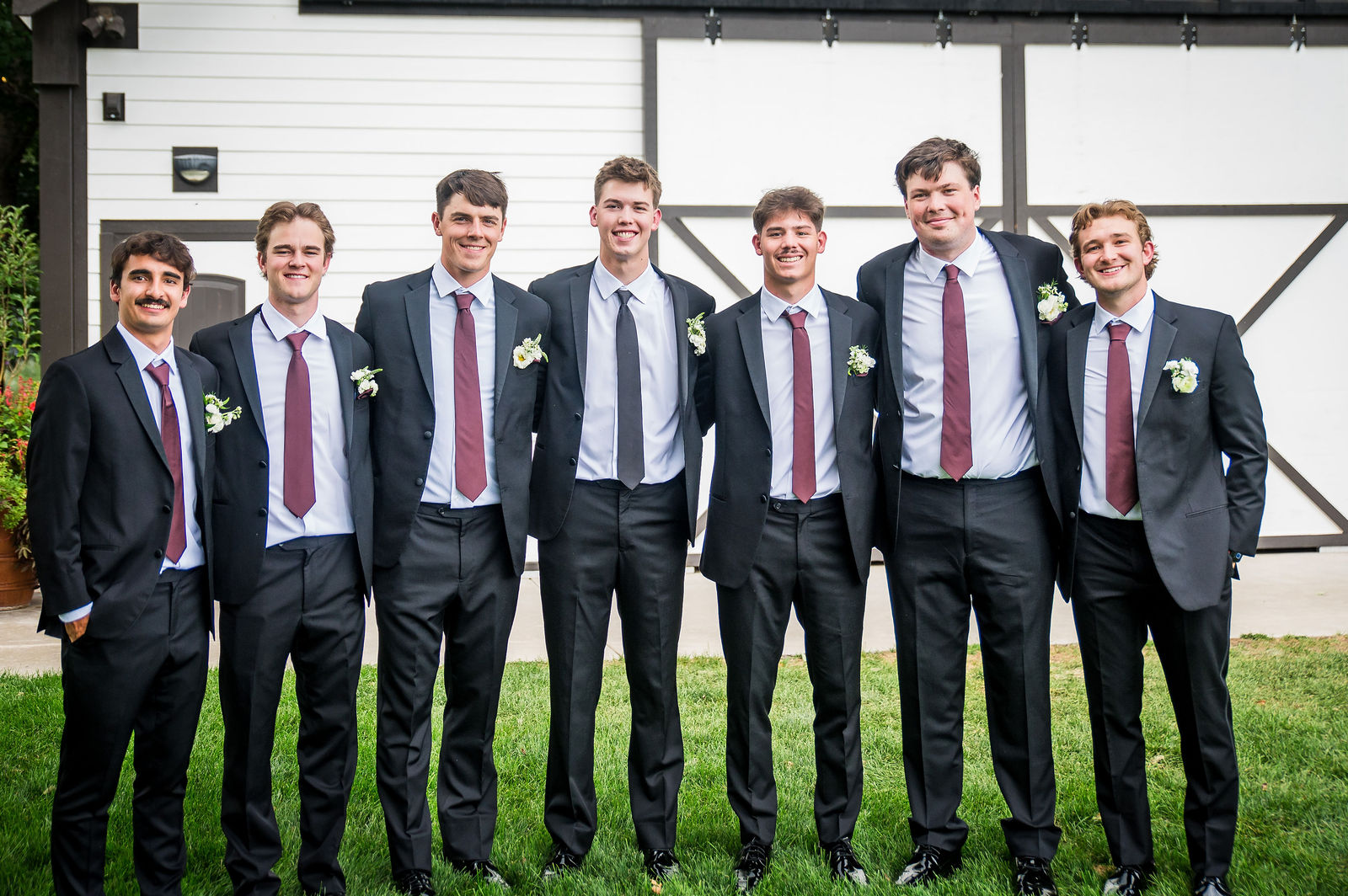 Groomsmen having fun outside the barn